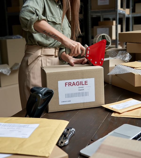 Worker preparing package for shipping