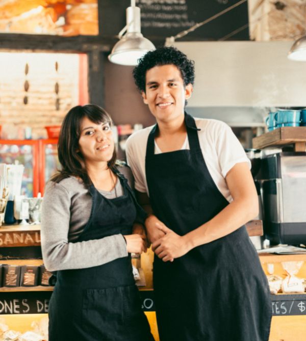 Small business owners standing in front of counter